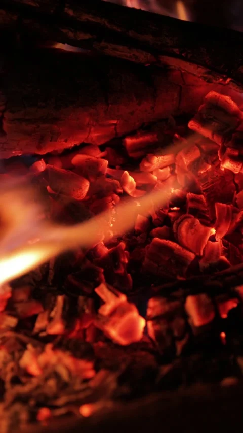 Slow motion, close-up view of a bonfire with vibrant orange flames gently Stock Footage 321531623