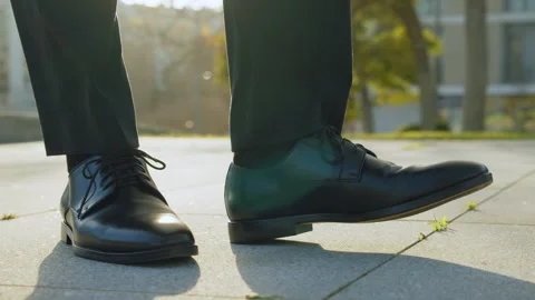 SLOW MOTION: Close-up view to the businessman in a black new shoes and  sta.. Stock Footage 262736896