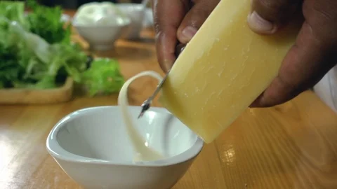 Slow motion - Close up view of chef hand chopping cheese on wooden chopping. Stock Footage 94176913