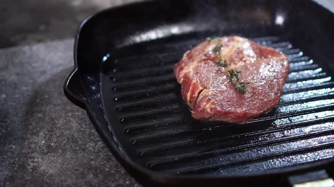 Slow motion close up view on chef cook rotating thick piece of raw beef meat Stock Footage 105895215