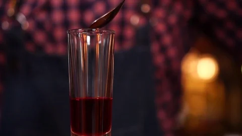 Slow motion close up view on cocktail bartending mixing orange juice with liquor Stock Footage 103805078