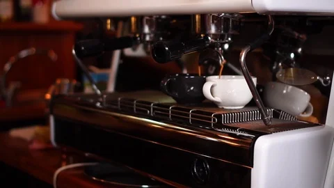Slow motion close up view on espresso coffee machine pouring hot drink in small Stock Footage 104372588