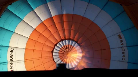 Slow motion close up view of the flame inside of a colorful hot air balloon Stock Footage 265776333