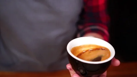 Slow motion close up view on hand movements of espresso coffee in small Video stock 104513474