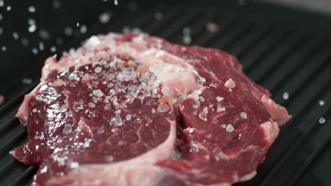 Slow motion close up view of putting fresh appetite steak meat beef Stock Footage 131728415