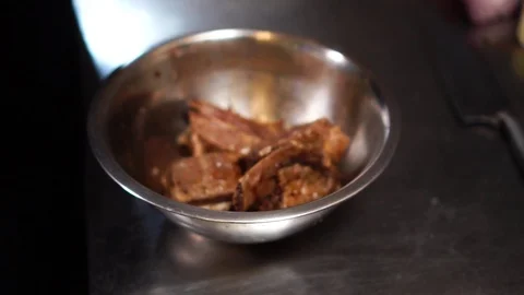 Slow motion close up view on raw beef meat in juicy sauce in steel mixing bowl Stock-Footage 105896678