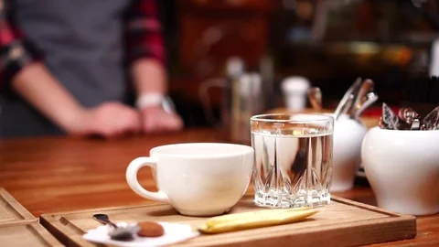Slow motion close up view on small white espresso americano coffee cup on wooden Stock Footage 104372149