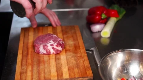 Slow motion close up view on spices and seasoning on thick slice of raw beef Stock Footage 105457070