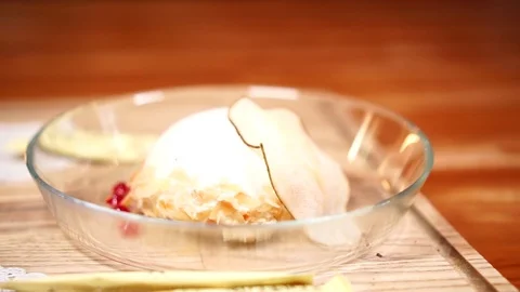 Slow motion close up view on sweet ice cream dessert in clear plate on wooden Stock-Footage 105894765