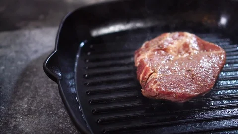 Slow motion close up view on thick piece of raw beef steak meat fried on grill Stock Footage 105895042