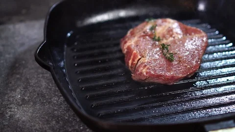 Slow motion close up view on thick piece of raw meat beef steak fried on hot Stock Footage 105895150