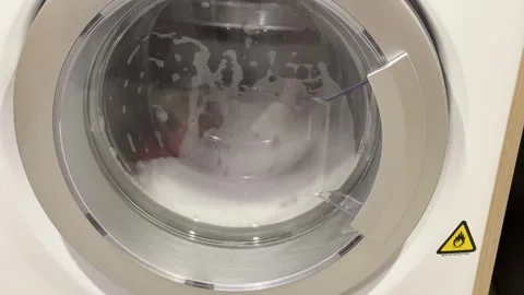 Slow Motion Close Up of Washing Machine Drum Rotating with Laundry Stock Footage 335119117