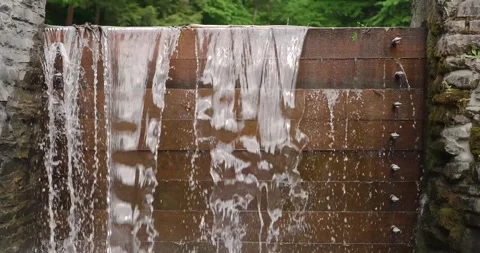Slow motion close up of water leaking through a wood plank dam. Stock Footage 243551239