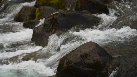 Slow Motion Close-Up of Water Rushing Over Volcanic Rocks in Iceland. Stock Footage 310677715