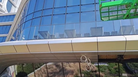 Slow Motion Close-up of Water Spraying Against Glass Facade Stock Footage 334550813