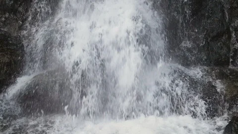 Slow motion close up of waterfall crashing against rocks in the forest Stock Footage 109620907