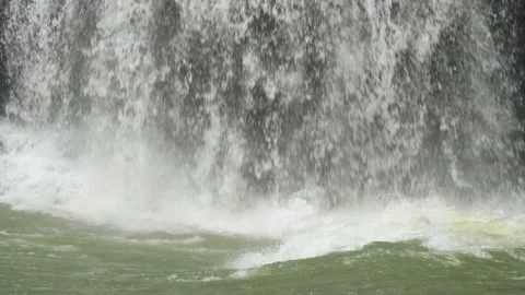Slow Motion Close Up of Waterfall Pouring into Green River, 4K Stock Footage 189508755