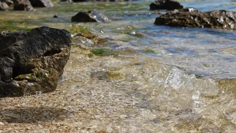 Slow motion close-up of a wave and a stone. Stock Footage 90135605