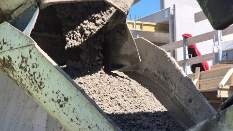 Slow Motion Close-up of Wet Concrete Pouring from Truck Chute Stockbeeldmateriaal 334062194