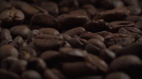 Slow motion close up of whole roasted coffee beans. Macro footage Stock Footage 136035222
