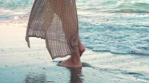Slow motion close-up of a woman’s feet walking along a tropical beach at sunset. Stock Footage 315528986