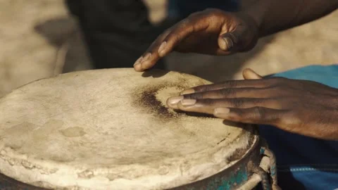 Slow motion close-up of woman’s hands playing traditional djembé Stock Footage 309912566