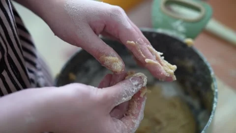 Slow motion close-up of a womans hands kneading sticky honey cake dough Stock Footage 320073418