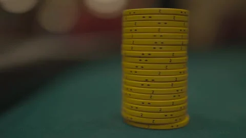 Slow motion close-up of yellow poker chip columns being removed Vídeos de archivo 334037150