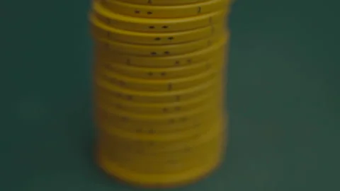 Slow motion close-up of yellow poker chip column Vídeos de archivo 334037192
