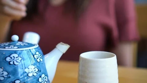 Slow motion close up young asian woman hand pouring hot green tea in Japanese Stock-Footage 100227226