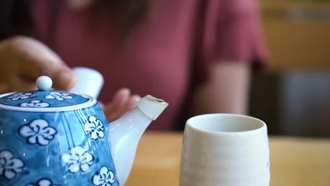 Slow motion close up young asian woman hand pouring hot green tea in Japanese Stock-Footage 100228629