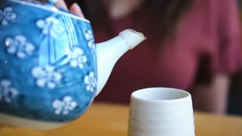Slow motion close up young asian woman hand pouring hot green tea in Japanese Stock-Footage 100228663