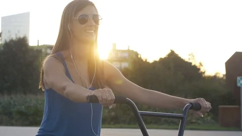 SLOW MOTION CLOSE UP Young beautiful woman with long brown hair on bmx bike Stock Footage 117892503
