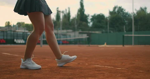 Slow motion close up: Young Caucasian teenager female tennis player serving Stock Footage 143378063