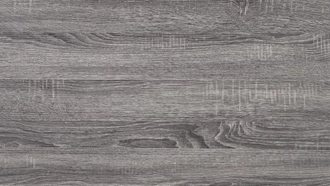 Slow-motion close-up zoom on grey laminate faux-wood furniture finish Stock Footage 313724925