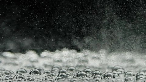Slow motion closeup abstract water bubbles on black background, macro soda drink Stock Footage 159780334