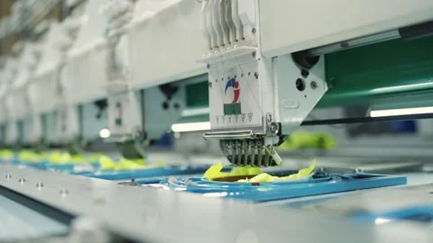 Slow motion closeup of automated sewing machine on yellow patch Stock Footage 321722949