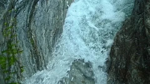 Slow motion of a closeup of a beautiful waterfall between stones of a rivulet Stock Footage 211492365