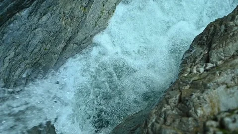 Slow motion of a closeup of a beautiful waterfall between stones of a rivulet Stock Footage 211492403