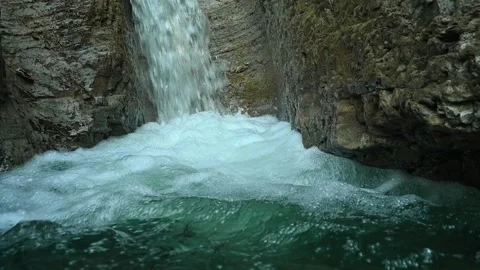 Slow motion of a closeup of a beautiful waterfall in between rocks Stock Footage 211496977