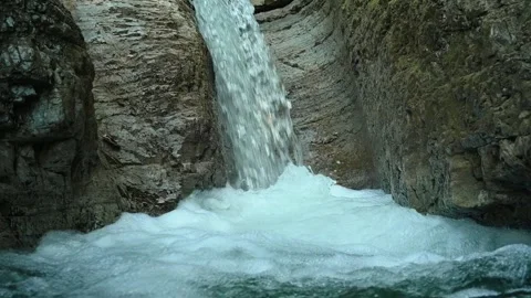 Slow motion of a closeup of a beautiful waterfall in between rocks Stock Footage 211497069