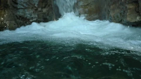 Slow motion of a closeup of a beautiful waterfall in between rocks Stock Footage 211497532