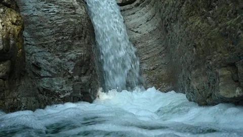 Slow motion of a closeup of a beautiful waterfall in between rocks Stock Footage 211497973