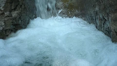 Slow motion of a closeup of a beautiful waterfall in between rocks Stock Footage 211498389