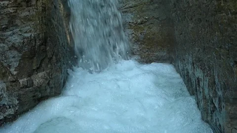 Slow motion of a closeup of a beautiful waterfall in between rocks Stock Footage 211499164