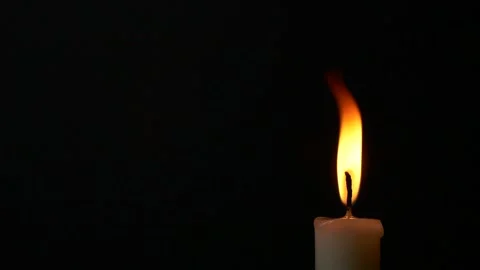 Slow motion closeup burning single candle flame isolated on black background, Stock Footage 171100045