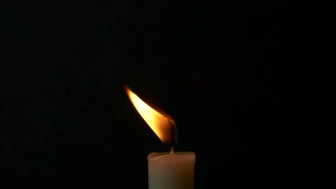 Slow motion closeup burning single candle flame isolated on black background, Stock Footage 171441270