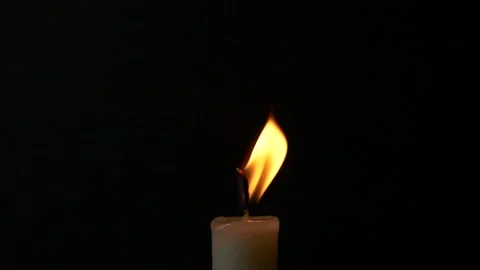 Slow motion closeup burning single candle flame isolated on black background Stock Footage 197097262