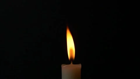 Slow motion closeup burning single candle flame isolated on black background Vídeo Stock 201047155
