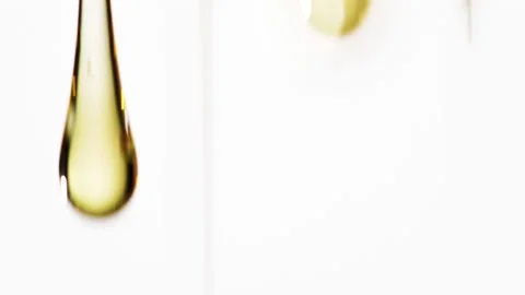 Slow motion closeup drops of golden sweet honey over white background Stock Footage 171552990